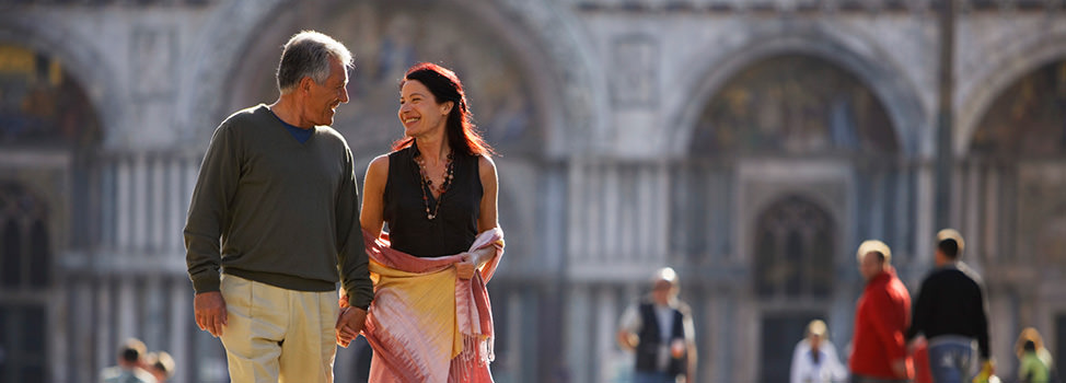 A mature couple walk hand-in-hand in Venice — Central Quest Introduction Agency, London